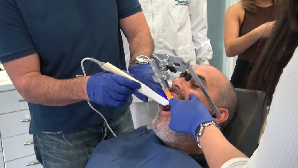 Dentist performing Facescan on patient
